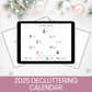 Digital tablet displaying a 2025 decluttering calendar on a white surface with Christmas decorations.